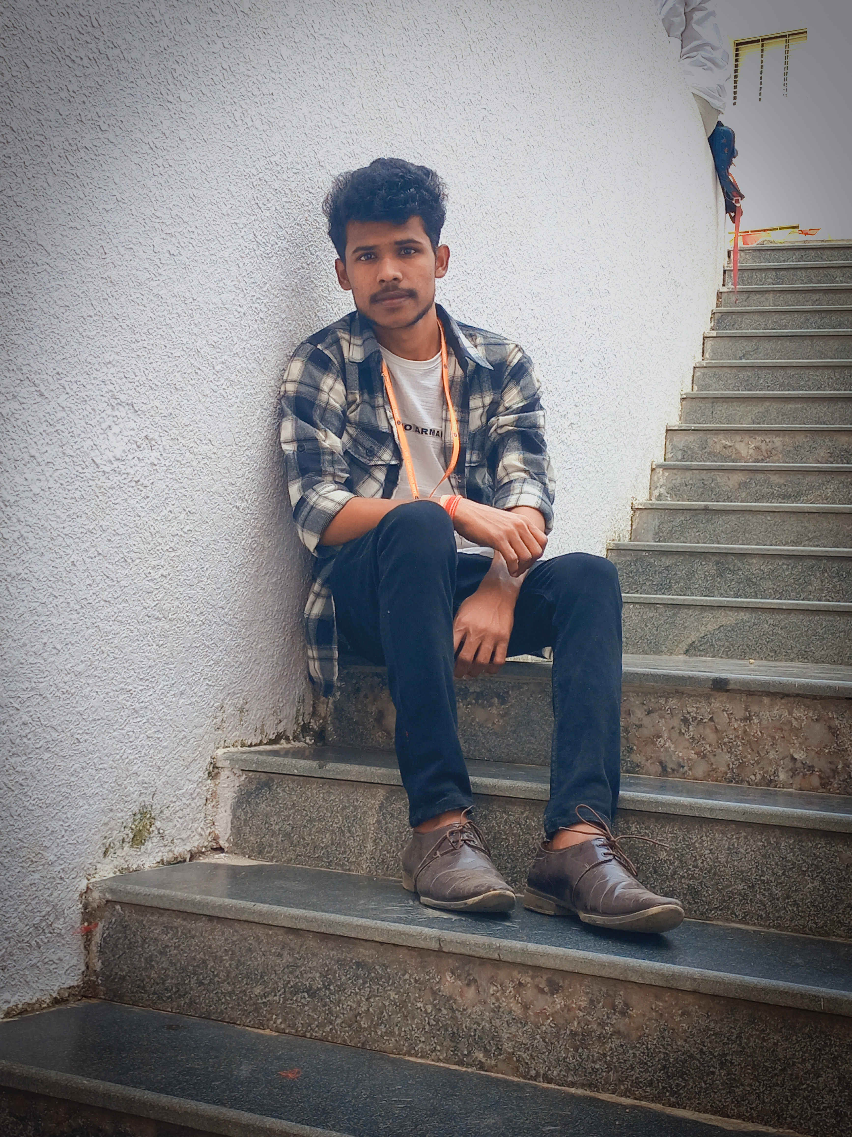 A man in a alice blue shirt with a thinking expression